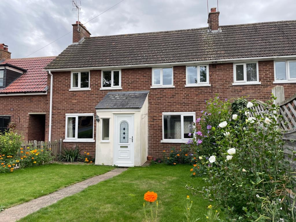 Lot: 57 - THREE-BEDROOM TERRACE HOUSE FOR REPAIR IN POPULAR ESSEX VILLAGE - front garden with path to front door